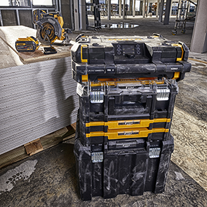 Several different workshop train boxes stand stacked on a construction site